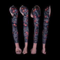 three leg tattoos with flowers on them