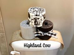 three rolls of toilet paper are stacked on top of each other with the words highland cow