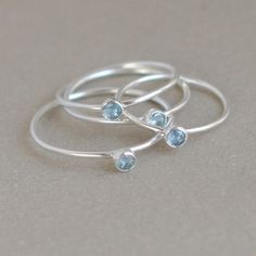 Aquamarine is the birthstone for March. Our slim sterling silver stacking gemstone ring looks lovely and delicate alone, or is perfect to stack for the mother, grandmother or other special someone who has lots of birthdays to remember! You may also simply choose your favorite colors of the season (like I often do!) and stack these silver beauties to your heart's content for a fun statement and a collection of rings that will go with any ensemble. {DETAILS}: * lab grown 3mm birthstone * 1mm band Dual Birthstone Ring, Mothers Ring, March Birthstone Ring, Mother Rings, Aquamarine Ring, March Birthstone, Ring Stacking, Initial Ring, Aquamarine Rings