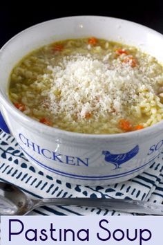 a bowl of chicken noodle soup with parmesan cheese