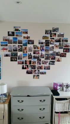 a heart shaped photo on the wall above a baby's crib and dresser