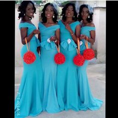 three women in blue dresses holding red pom poms