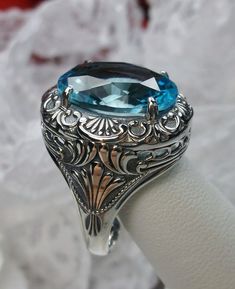 Simulated Aquamarine Ring Description Lion Design#218 MADE TO ORDER I now offer this is a brand new Art Deco/Victorian reproduction ring in solid sterling silver. The gorgeous filigree ring is set with a simulated Aquamarine. The high-quality round cut Aquamarine is 16mm by 12mm. The inside of the band is marked 925 for sterling. Notice the beautiful craftsmanship of the silver filigree setting. Feel free to ask questions and thanks for looking at my auctions. All rings can be sized by any jewel Oval White Gold Engraved Ring With Gemstone, Antique Oval Topaz Ring For Formal Occasions, Antique Oval Sapphire Ring Hallmarked, Oval Blue Intaglio Ring, Victorian Oval Intaglio Rings, Victorian Oval Engraved Ring, Heirloom Oval Topaz Ring Hallmarked, Victorian Engraved Oval Ring, Heirloom Oval Ring With Intricate Design