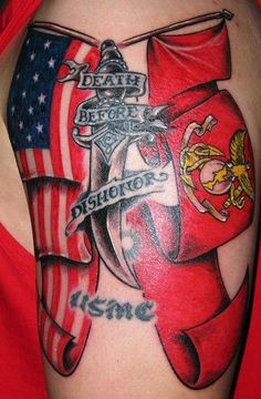 a woman's arm with an american flag and anchor tattoo on the side of her shoulder