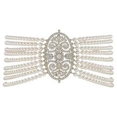 A diamond and cultured pearl chocker necklace, the Edwardian diamond centerpiece with openwork scroll design decorations, set with old European cut diamonds estimated to weigh in total approximately 4 ¾ carats, all millegrain-set in platinum, circa 1910, strung with nine rows of cultured pearls measuring 3.5-4mm n diameter, to a bayonet-style clasp, accompanied by detachable brooch fitting, the centerpiece measuring 4.4 x 2.6cm, the necklace measuring 34 x 3.3cm, gross weight 70 grams. This anti Ballet Necklace, Sapphire Diamond Necklace, Rock Crystal Necklace, Diamond Centerpiece, Amber Bead Necklace, Natural Pearl Necklace, Pearl And Diamond Necklace, Chocker Necklace, Gold Link Chain