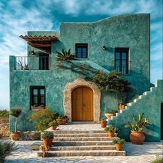 an adobe style house with steps leading up to the front door