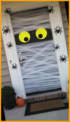 a door decorated with spider webs and eyes