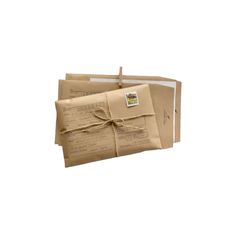 three brown packages tied with twine on top of each other