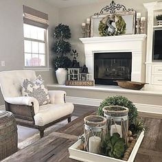 a living room filled with furniture and a fire place in the middle of a room