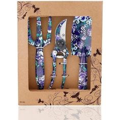 three forks and two knives in a box with butterflies on the side, one is purple