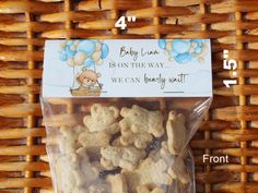 a bag of baby bear cookies sitting on top of a table next to a basket