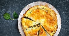 a quiche with spinach and cheese on a plate