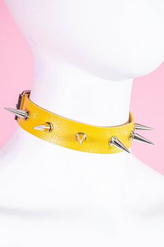 One big ray of sunshine but with a twist. This choker necklace is 17" Long and has adjustable straps .Featuring sliver spikes details around the collar.