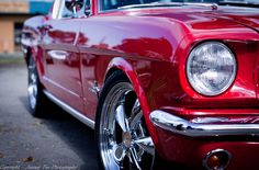 the front end of an old red car