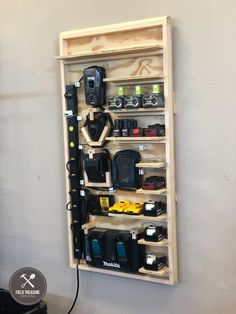 a wooden shelf with many different types of electronic devices on it, hanging from the wall