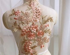 the back of a dress with flowers on it