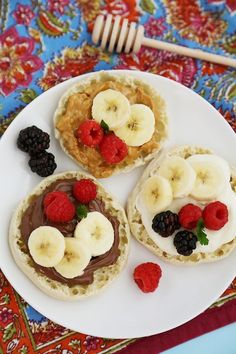 three pastries on a plate topped with fruit