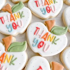 decorated cookies with thank you written on them are displayed in the shape of heart - shaped hearts