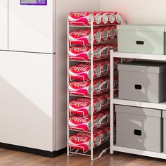 a stack of coca - cola cans sitting on top of a shelf next to a freezer