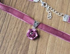 "Pink-purple velvet ribbon choker with sculpted handmade rose. Material of flower is polymer clay with special pearl cover. Each petal of flower made by hand Dia flower about 15 mm/ 0.55 \" Length of necklace is adjustable:  10-12 inches/ 25,4 - 30,5 cm 11-13 inches/ 28-33 cm 12-14 inches/ 30.5- 35.5 cm 13-15 inches/ 33-38 cm 14-16 inches/ 35.5 cm-40.5 cm 15-17 inches/ 38,1 cm- 43,2 cm 16-18 inches/ 40.6 cm- 45.7 cm 17-19 inches/ 43 cm - 48 cm 18-20 inches/ 45,5- 50.8 cm Width of ribbon 10 mm / 0.4 inch If you need other length of necklace let me know and I will make it for you. Polymer clay isn't afraid of water, strong and non-toxic. Gorgeous gift for women and girls as handmade item ALL CHOKERS - https://www.etsy.com/shop/BuduartJewelry?ref=simple-shop-header-name&listing_id=694544029§i Polymer Clay Cute, Purple Flower Necklace, Clay Cute, Purple Choker, Navy Blue Earrings, Rose Choker, Ribbon Choker, Rose Violette, Handmade Rose