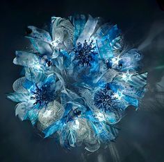 a blue and white flower arrangement on a black background