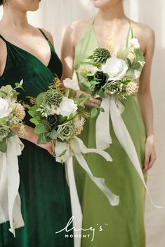 two bridesmaids in green dresses holding bouquets