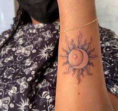 a woman with a sun tattoo on her arm