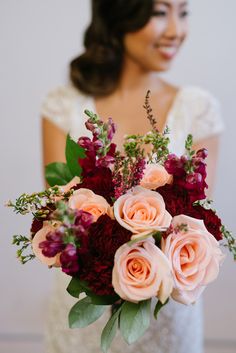 a woman holding a bouquet of flowers in front of her face and color swatches