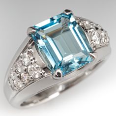 This cool-hued ring is centered with one (1) emerald cut natural aquamarine set into a four-prong setting. The shoulders of the ring are each accented with eight (8) shared bead set round brilliant cut diamonds. The ring measures 10.7mm at the top, rises 6.7mm above the finger, and tapers to 2.9mm wide by 1.0mm thick at the base of the shank. The ring is crafted in platinum and is currently a size 6.25. Vintage Aquamarine Ring, Aquamarine Ring Vintage, Vintage Cocktail Ring, Emerald Cut Rings, Aquamarine Jewelry, Aquamarine Ring, Bead Set, Aquamarine Rings, Natural Aquamarine