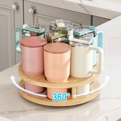 a wooden tray holding four different colored coffee mugs on top of a kitchen counter