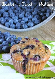 blueberry zucchini muffins with fresh blueberries in the background