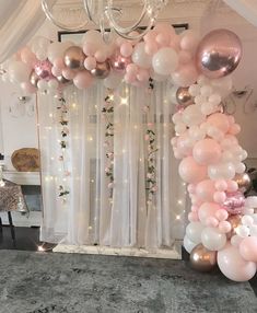 the balloon arch is decorated with pink, white and gold balloons for an elegant look