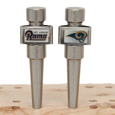 pair of st louis rams bottle openers sitting on top of a piece of wood