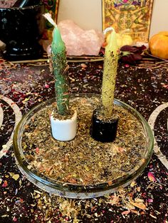 there are two candles that are in the middle of a tray with confetti and sprinkles on it