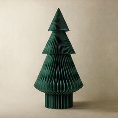 a green christmas tree made out of folded paper