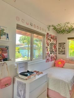 a bedroom with a white bed and pink accessories on the nightstands next to it