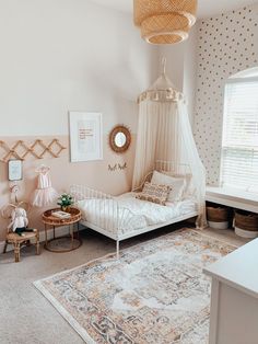 a white bed sitting next to a window in a bedroom