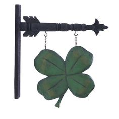 a green four leaf clover hanging from a hook