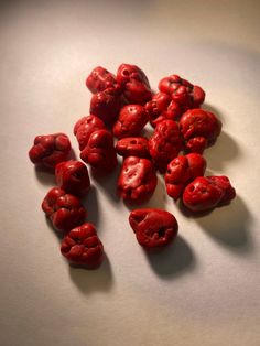 some red berries are on a white surface