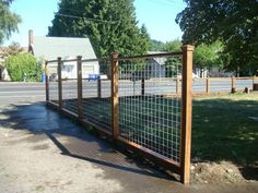 the fence is made of wood and has metal bars on each side, along with a wooden post