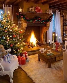 a living room with a christmas tree in the corner and other decorations on the fireplace