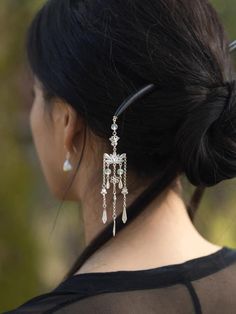 This hairpin is part of the "Lotus Pond Clear Dew" collection. It is an original design made from 999 fine silver, featuring cloisonné work inspired by the Forbidden City. The hairpin incorporates intangible cultural heritage elements, such as lotus flowers and butterflies, and includes a long tassel. The hairpin is made with sandalwood and is designed to be a beautiful and culturally significant accessory. length:hairpin 18cm              tassel 9cm Caring for a Wood Hairpin involves several steps to maintain its beauty and extend its lifespan.Here are some recommendations: Avoid Moisture:Do not wear the hairpin when bathing or washing your hair, and keep it away from moisture. Cleaning and Drying:If the hairpin gets dirty, gently wipe it with a slightly damp soft cloth, and then immediat Hairpin Chinese, Hair Pin Chinese, Chinese Jade Hairpin, Traditional Chinese Hairpin, Pink Japanese Hairpin, Silver Hair Pin, Flower Hair Pin, Hair Sticks, Chinese Style