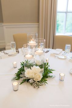 a table with candles and flowers on it