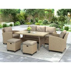 an outdoor patio furniture set with beige cushions