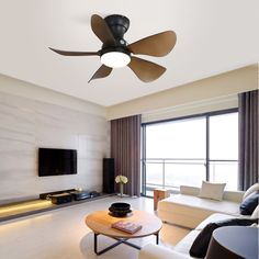 a living room with couches and a ceiling fan in the middle of the room