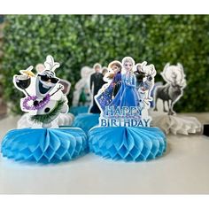 two frozen princess figurines sitting on top of a table