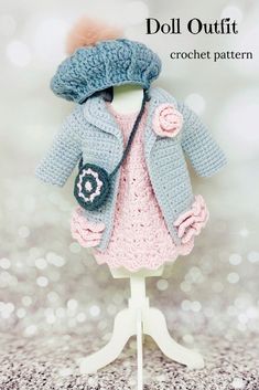 a crochet doll is wearing a knitted coat and hat with pom - pom