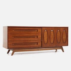 the sideboard is made out of wood and has two doors on one side, and three drawers on the other