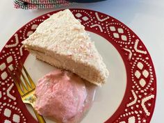 a piece of cake sitting on top of a red and white plate next to a fork