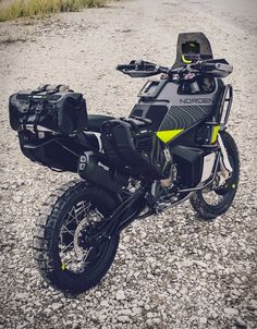 a dirt bike parked on top of a gravel road